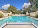 Community pool with convenient access steps and safety rails at 209 Tomoka Trl # 209, Longwood, FL 32779