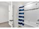 Bathroom with tub and blue and white shower curtain at 236 Denali St, Haines City, FL 33844