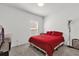 Bedroom with red bedding and large window at 236 Denali St, Haines City, FL 33844
