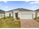 One-story home with two-car garage and landscaped front yard at 236 Denali St, Haines City, FL 33844