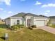 One-story home with a two-car garage and well-manicured lawn at 236 Denali St, Haines City, FL 33844