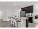 Modern kitchen with island, stainless steel appliances, and dark cabinets at 236 Denali St, Haines City, FL 33844