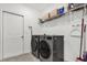 Laundry room with washer, dryer, and shelving at 236 Denali St, Haines City, FL 33844