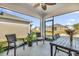 Relaxing screened porch with seating and outdoor table at 236 Denali St, Haines City, FL 33844