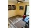 Bedroom with wood-look flooring, ceiling fan and red chair at 3291 Sw 133Rd Lane Rd, Ocala, FL 34473