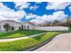House exterior showing a landscaped lawn, driveway, and a curved sidewalk at 441 Tallow Wood Cir, Debary, FL 32713