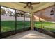 Bright screened porch overlooking grassy backyard at 441 Tallow Wood Cir, Debary, FL 32713