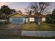 Charming ranch home with gray siding, yellow accents, and a two-car garage at 800 Lighthouse Cv, Sanford, FL 32773