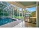 Pool patio with built-in outdoor kitchen and seating area at 8359 Grey Bark Ct, Sanford, FL 32771