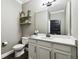 Modern bathroom with white cabinets and a floating shelf at 9482 Bolero Rd, Winter Garden, FL 34787