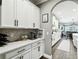 White kitchen with quartz countertops, stainless steel appliances, and an island at 9482 Bolero Rd, Winter Garden, FL 34787