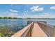 Relaxing pier extending over a lake with lily pads at 9482 Bolero Rd, Winter Garden, FL 34787