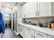 Bright laundry room with white cabinets and quartz countertops at 9482 Bolero Rd, Winter Garden, FL 34787