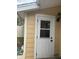 Exterior view of a house with a white door and yellow siding at 5363 Skelly Sq # 1005, Orlando, FL 32812