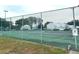 Community tennis court with green surface and surrounding fence at 5363 Skelly Sq # 1005, Orlando, FL 32812