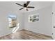 Bright bedroom with wood-look floors and large windows at 2588 Sun Acres Blvd, Auburndale, FL 33823