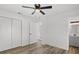 Spacious bedroom with double closets and wood-look floors at 2588 Sun Acres Blvd, Auburndale, FL 33823