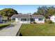 Newly renovated home with a spacious lawn and driveway at 2588 Sun Acres Blvd, Auburndale, FL 33823