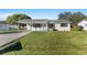Newly renovated home with a spacious lawn and driveway at 2588 Sun Acres Blvd, Auburndale, FL 33823