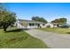 Newly renovated home with a spacious lawn and driveway at 2588 Sun Acres Blvd, Auburndale, FL 33823