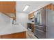 Kitchen with wood cabinets, stainless steel appliances and quartz countertops at 2588 Sun Acres Blvd, Auburndale, FL 33823