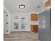 Kitchen with wood cabinets, patio access, and stainless steel refrigerator at 2588 Sun Acres Blvd, Auburndale, FL 33823
