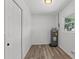Laundry room with vinyl flooring and water heater at 2588 Sun Acres Blvd, Auburndale, FL 33823