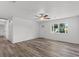 Living room features wood-look floors and large window at 2588 Sun Acres Blvd, Auburndale, FL 33823