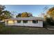 Newly renovated white house with gray roof and landscaping at 26221 Se 159Th Ln, Umatilla, FL 32784