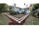 Attractive walkway leads to charming white house with blue trim at 26221 Se 159Th Ln, Umatilla, FL 32784