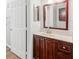 Bathroom with dark wood vanity, mirror, and neutral countertop at 3725 Conroy Rd # 2131, Orlando, FL 32839