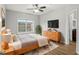 Virtually staged bedroom featuring wooden furniture and neutral-toned decor at 3725 Conroy Rd # 2131, Orlando, FL 32839