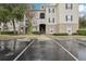 Exterior view of condo building with parking lot and landscaping at 3725 Conroy Rd # 2131, Orlando, FL 32839