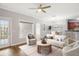 Virtually staged living room with plush seating, dining area, and view of balcony at 3725 Conroy Rd # 2131, Orlando, FL 32839