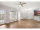 Living room with hardwood floors, ceiling fan and balcony access at 3725 Conroy Rd # 2131, Orlando, FL 32839