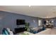Living room with sofas, large TV, and sliding doors to backyard at 4410 Petunia St, Lake Hamilton, FL 33851