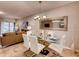 Modern dining room with glass table, white chairs, and a large mirror at 6098 Galloping Dr, Apopka, FL 32712