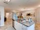 Kitchen island with granite countertops and stainless steel sink, open to living area at 6098 Galloping Dr, Apopka, FL 32712