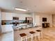 Modern kitchen with white cabinets, granite counters and stainless steel appliances at 6102 Galloping Dr, Apopka, FL 32712