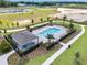 Community pool with lounge chairs and shaded seating area at 6102 Galloping Dr, Apopka, FL 32712