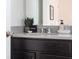 Bathroom features dark vanity, granite countertop, and sleek fixtures at 8933 Amelia Downs Trl, Kissimmee, FL 34747