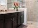 Modern bathroom with dark vanity and walk-in shower at 8933 Amelia Downs Trl, Kissimmee, FL 34747