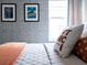Bedroom featuring a comfy bed, geometric wallpaper, and a 'Don't Panic' pillow at 8933 Amelia Downs Trl, Kissimmee, FL 34747