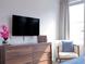 Bedroom with TV, dresser, and armchair at 8933 Amelia Downs Trl, Kissimmee, FL 34747