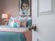 Stylish bedroom with Audrey Hepburn art and teal bedding at 8933 Amelia Downs Trl, Kissimmee, FL 34747