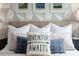 Cozy bedroom with geometric wallpaper, plush bedding, and decorative pillows at 8933 Amelia Downs Trl, Kissimmee, FL 34747