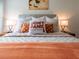 Relaxing bedroom with burnt orange bedding and art at 8933 Amelia Downs Trl, Kissimmee, FL 34747