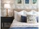 Bedroom with nightstand and geometric wallpaper, plush bedding, and pillows at 8933 Amelia Downs Trl, Kissimmee, FL 34747