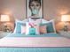 Bedroom with Audrey Hepburn art and pink and teal bedding at 8933 Amelia Downs Trl, Kissimmee, FL 34747