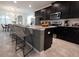 Modern kitchen with dark cabinetry and large island at 8933 Amelia Downs Trl, Kissimmee, FL 34747